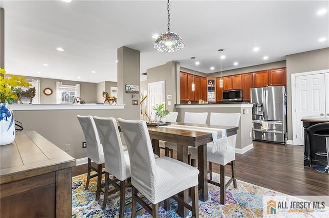 dining room with dark wood-type flooring, baseboards, and recessed lighting
