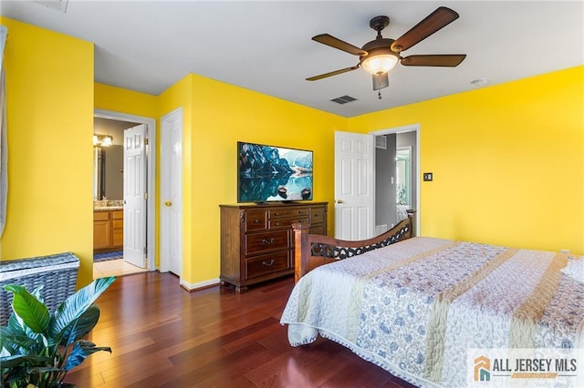 bedroom featuring dark wood-style flooring, baseboards, a ceiling fan, connected bathroom, and visible vents