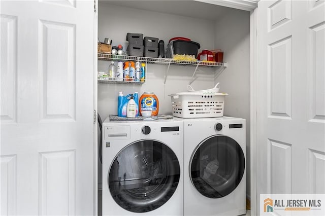 clothes washing area featuring washer and clothes dryer and laundry area