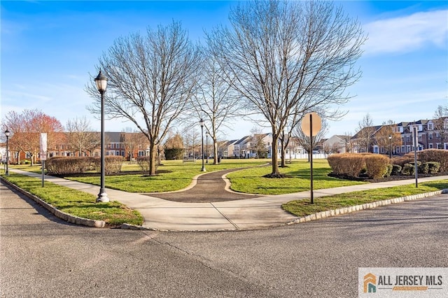view of community featuring a residential view and a yard