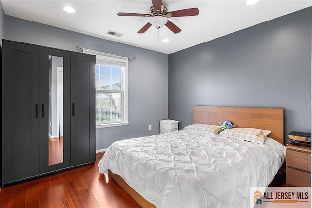 bedroom featuring visible vents, ceiling fan, recessed lighting, and dark wood finished floors
