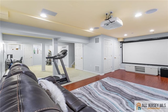 home theater room with recessed lighting, visible vents, and wood finished floors