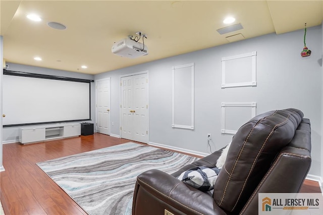 cinema room featuring recessed lighting, baseboards, and wood finished floors