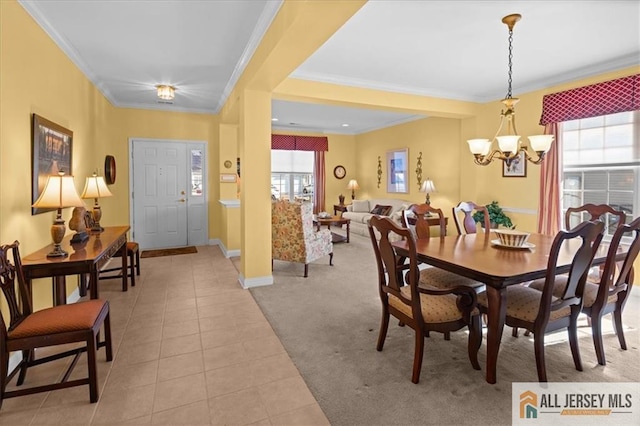 dining area featuring ornamental molding, light colored carpet, and a chandelier