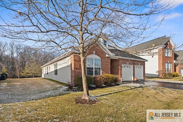 view of front of house with a garage and a front lawn