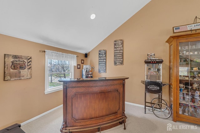 bar with baseboards, lofted ceiling, and light colored carpet