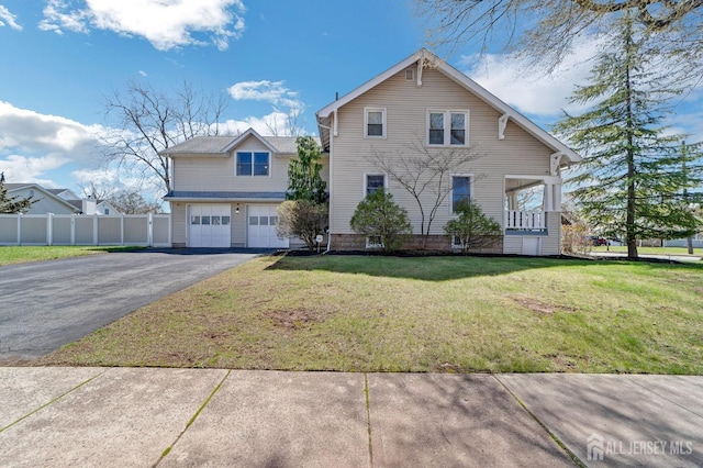 view of front of property featuring a garage, fence, aphalt driveway, and a front yard