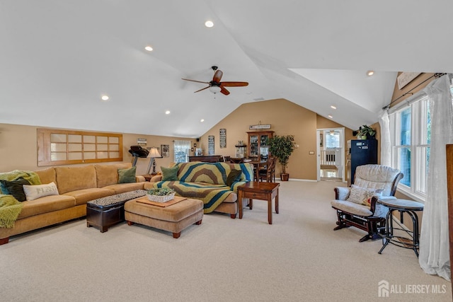 living room with recessed lighting, light carpet, lofted ceiling, and plenty of natural light