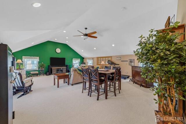 dining area featuring light colored carpet, ceiling fan, and a healthy amount of sunlight
