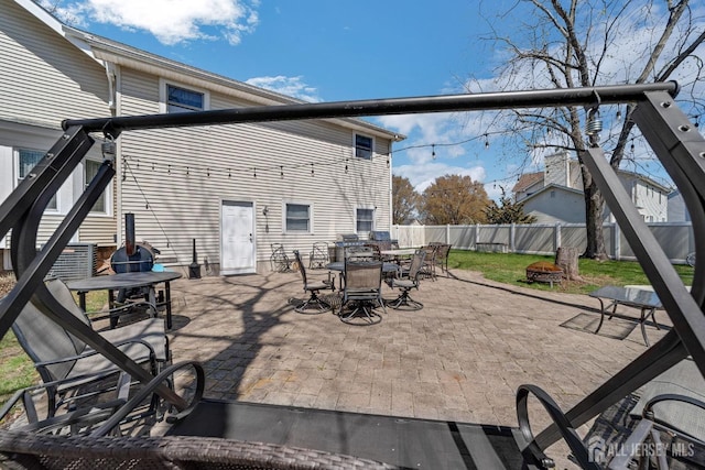 view of patio / terrace featuring outdoor dining space, a fenced backyard, and a fire pit