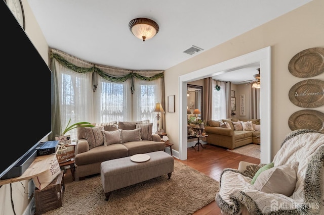 living area with wood finished floors and visible vents