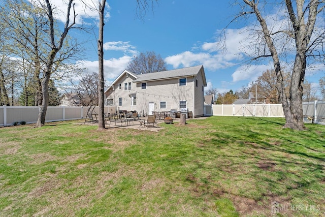 back of property featuring a patio, a yard, and a fenced backyard