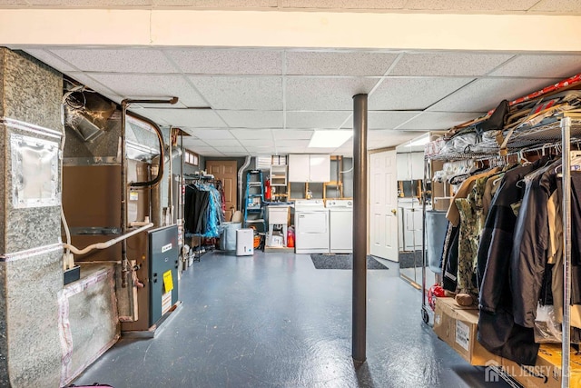 unfinished below grade area with washer and clothes dryer and a drop ceiling