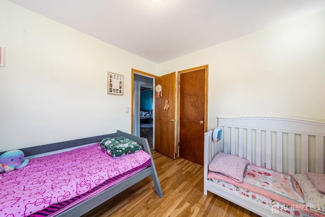 bedroom with wood finished floors