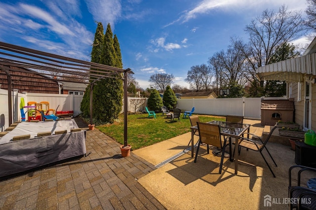 view of patio / terrace with a fenced backyard, outdoor dining space, and an outdoor fire pit