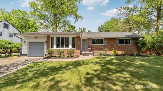 single story home with a front yard, an attached garage, brick siding, and driveway