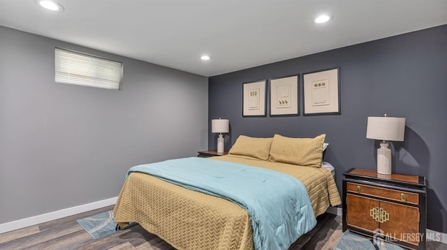 bedroom with wood finished floors, baseboards, and recessed lighting