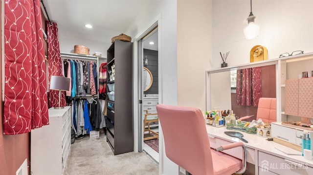 spacious closet with light colored carpet