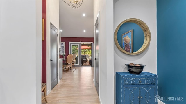 hall with baseboards, recessed lighting, and wood finished floors