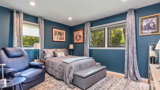 bedroom featuring wood finished floors, baseboards, and recessed lighting