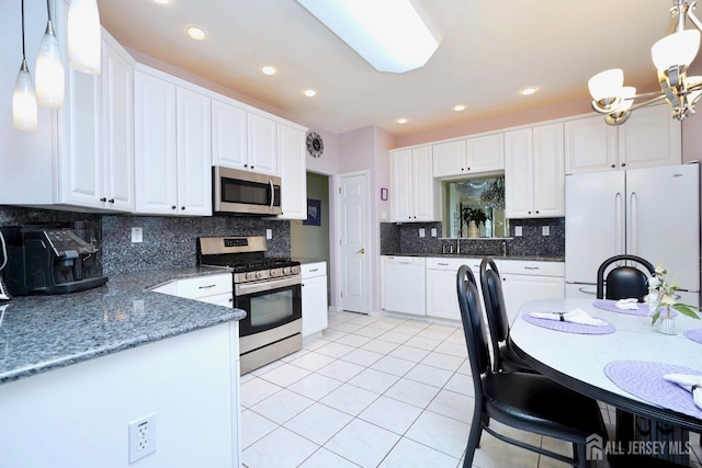 137 Murano Ave, Monroe, NJ 08831 - kitchen featuring appliances with stainless steel finishes, white cabinets, light tile patterned floors, hanging light fixtures, and recessed lighting