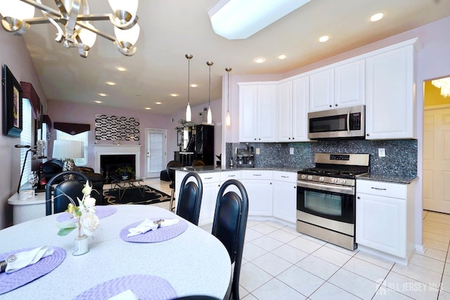 137 Murano Ave, Monroe, NJ 08831 - kitchen with appliances with stainless steel finishes, a chandelier, light tile patterned flooring, open floor plan, and decorative backsplash