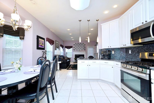 137 Murano Ave, Monroe, NJ 08831 - kitchen featuring stainless steel appliances, a chandelier, tasteful backsplash, light tile patterned floors, and open floor plan