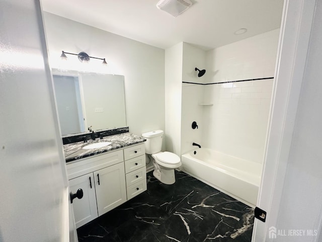 full bathroom featuring marble look tile flooring, vanity, toilet, and shower / tub combination