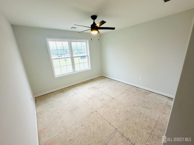 spare room featuring baseboards and a ceiling fan