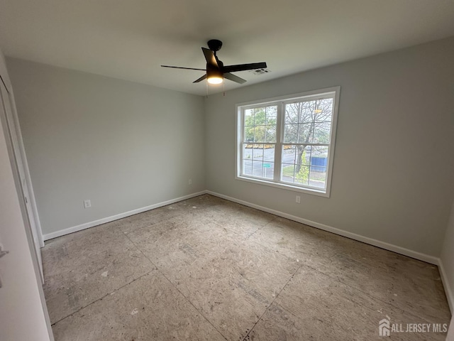 empty room featuring baseboards and ceiling fan