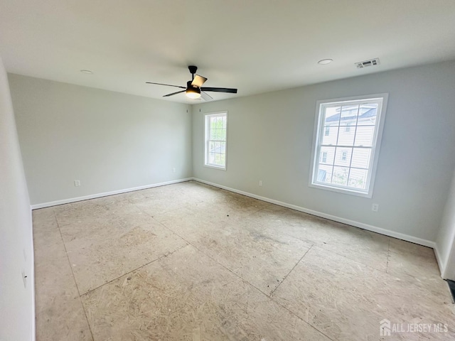 unfurnished room with ceiling fan and baseboards