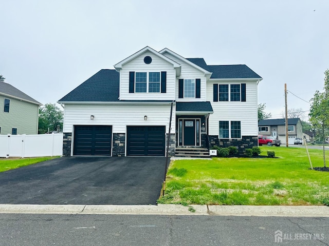 view of front of home featuring asphalt driveway, stone siding, and a garage
