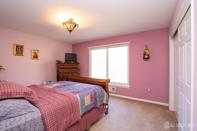 carpeted bedroom with a closet