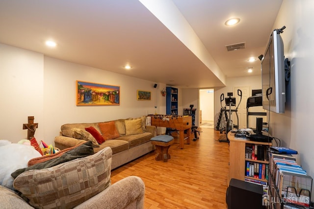 living room with recessed lighting, visible vents, and light wood-style flooring