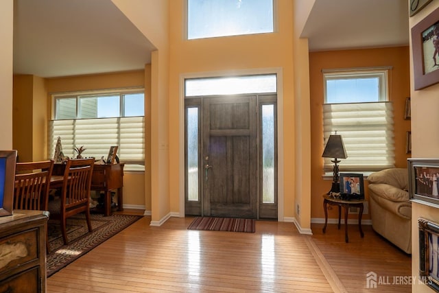 foyer featuring light wood-style flooring and baseboards