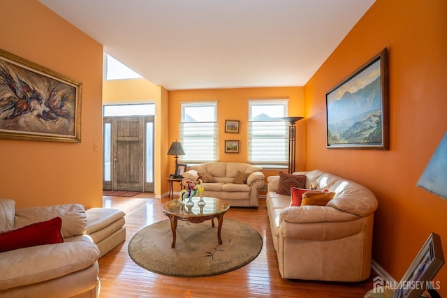 living room featuring baseboards and hardwood / wood-style floors