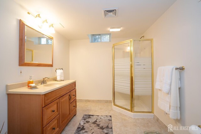 bathroom featuring vanity, an enclosed shower, and tile patterned flooring