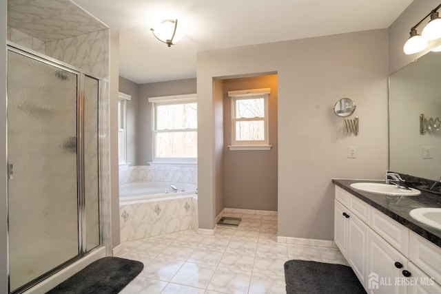 bathroom featuring a sink, a stall shower, a bath, and double vanity