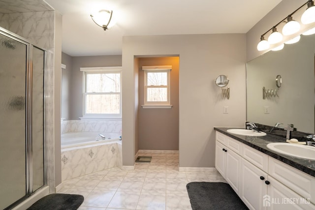 bathroom with a sink, a garden tub, a stall shower, and double vanity