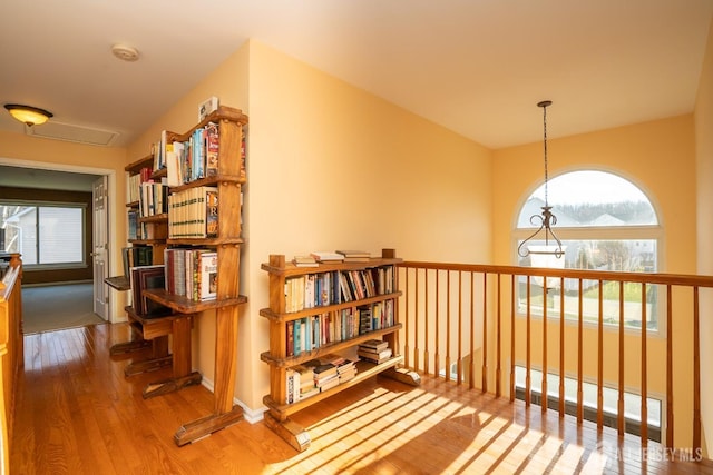 hallway with wood finished floors and baseboards