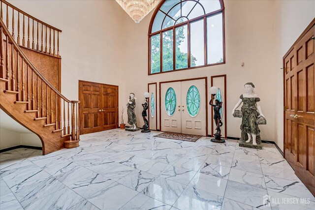 16 Benedek Rd, Princeton, NJ 08540 - entryway featuring a towering ceiling, stairs, marble finish flooring, and baseboards
