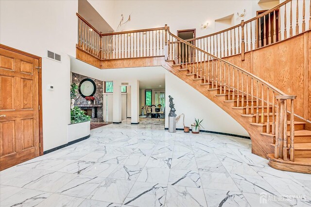 16 Benedek Rd, Princeton, NJ 08540 - foyer entrance with stairway, a high ceiling, baseboards, marble finish floors, and a fireplace