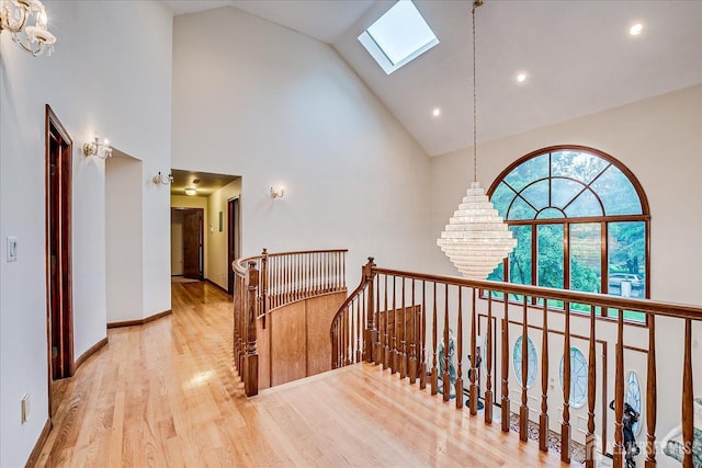 16 Benedek Rd, Princeton, NJ 08540 - hall with a skylight, high vaulted ceiling, wood finished floors, an upstairs landing, and a chandelier
