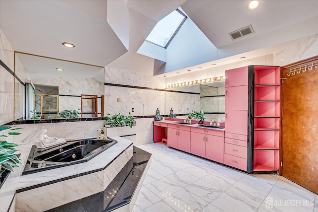 16 Benedek Rd, Princeton, NJ 08540 - kitchen featuring red cabinetry, a skylight, light marble finish floors, a sink, and tile walls
