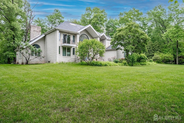 16 Benedek Rd, Princeton, NJ 08540 - view of home's exterior featuring a chimney, a yard, and brick siding