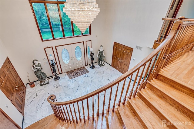 16 Benedek Rd, Princeton, NJ 08540 - entrance foyer with a chandelier, a towering ceiling, wood finished floors, and stairs