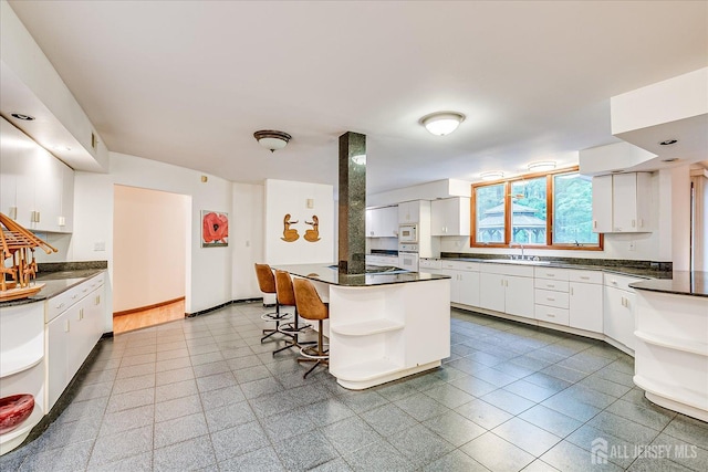16 Benedek Rd, Princeton, NJ 08540 - kitchen featuring open shelves, a sink, dark countertops, and white cabinetry
