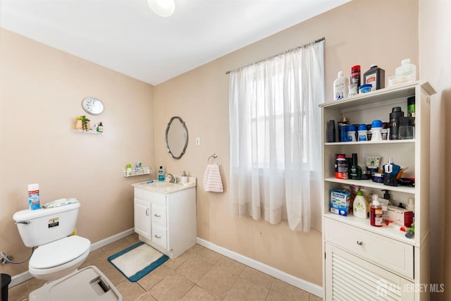 bathroom featuring tile patterned floors, vanity, and toilet