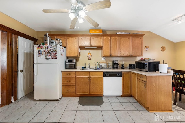 kitchen featuring lofted ceiling, sink, white appliances, light tile patterned floors, and ceiling fan