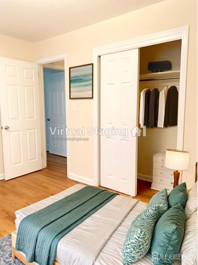 bedroom featuring wood-type flooring and a closet